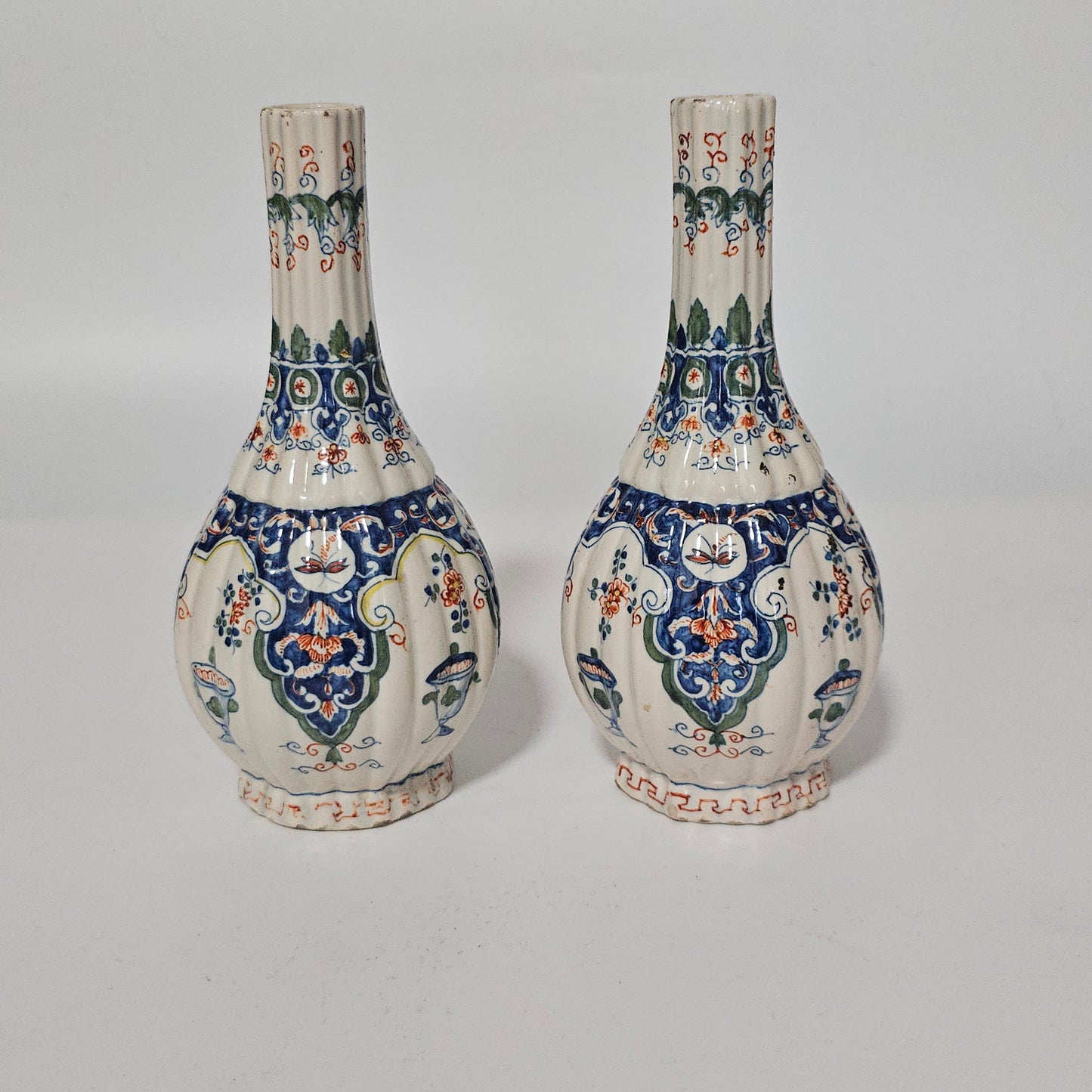 A Matched Pair of Dutch Delft Ribbed Bottle Vases c 1700/1720