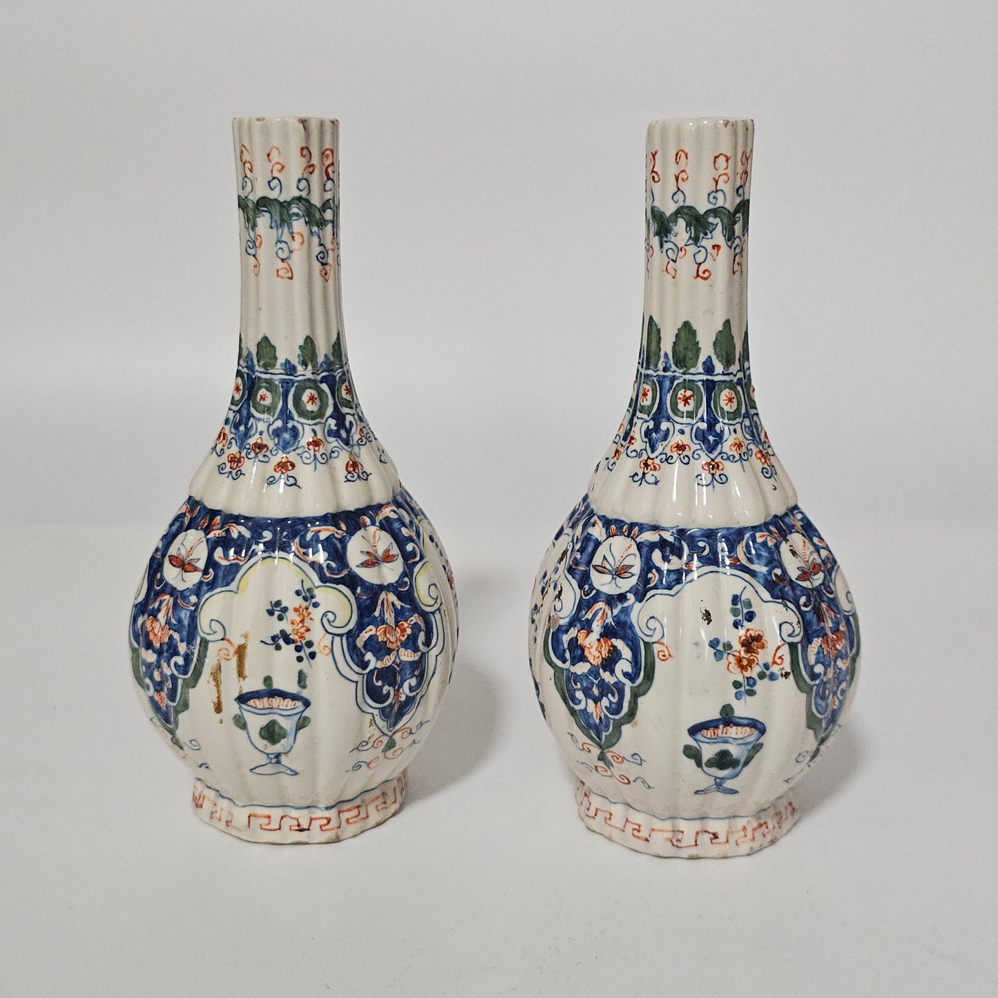A Matched Pair of Dutch Delft Ribbed Bottle Vases c 1700/1720