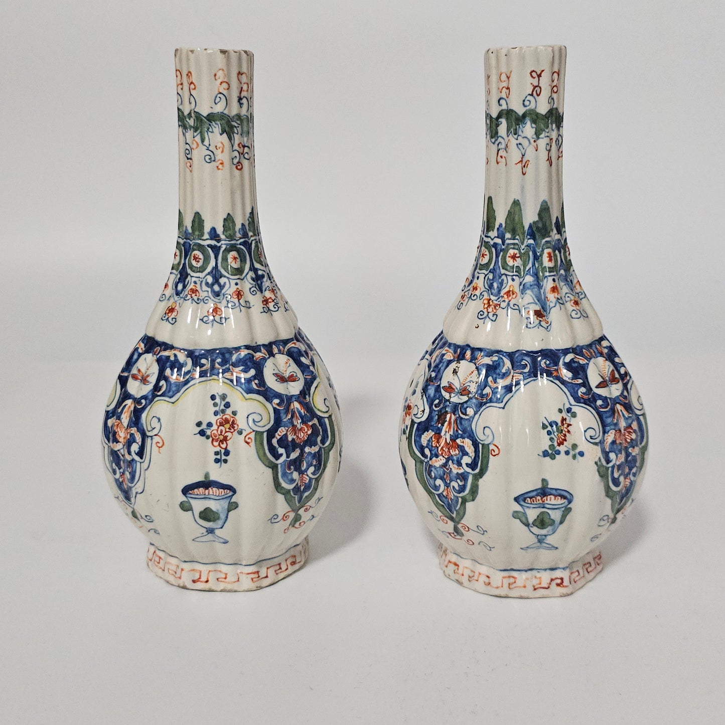 A Matched Pair of Dutch Delft Ribbed Bottle Vases c 1700/1720