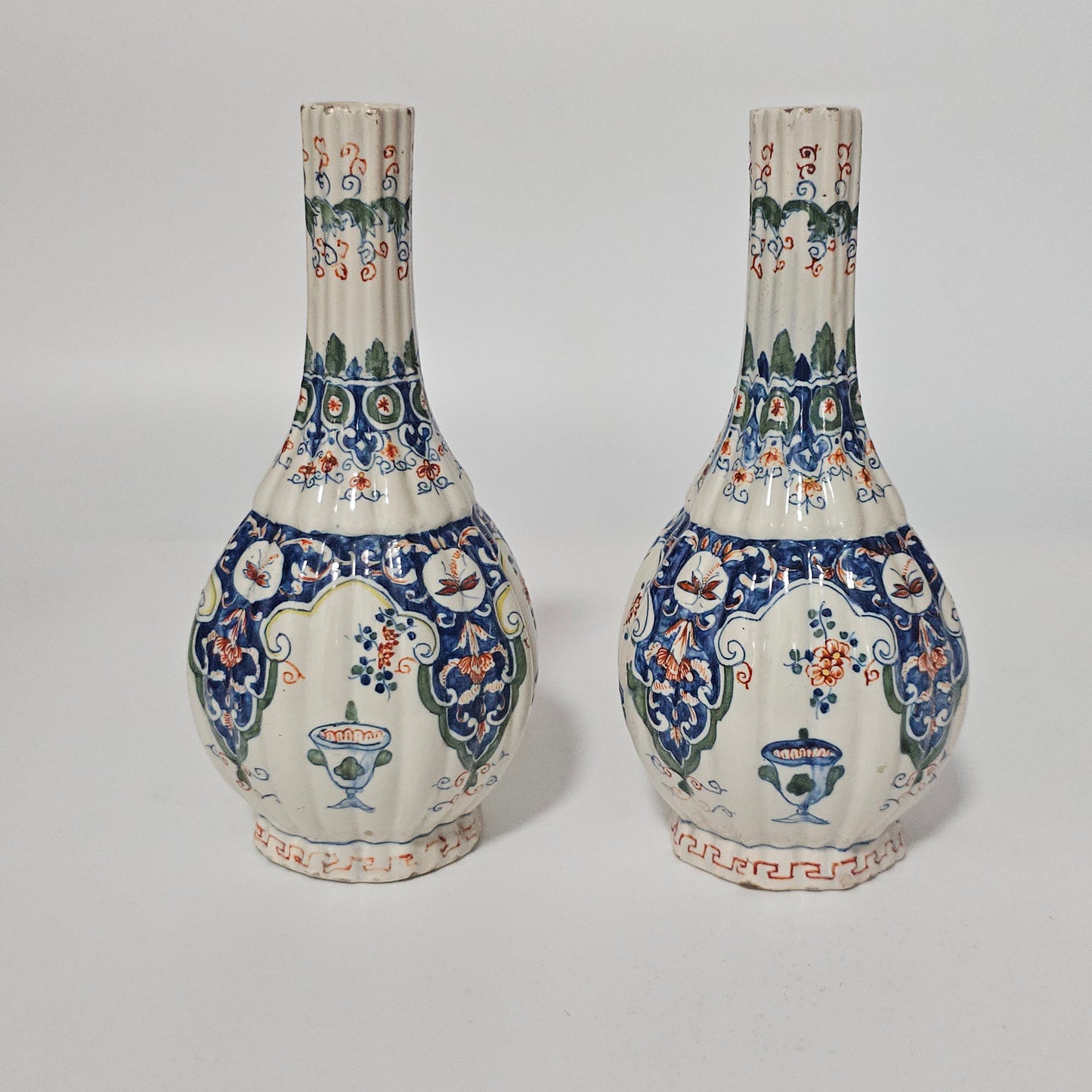 A Matched Pair of Dutch Delft Ribbed Bottle Vases c 1700/1720