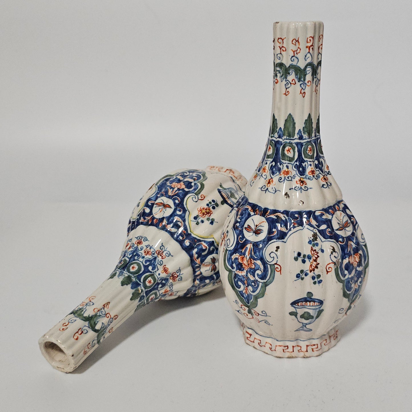 A Matched Pair of Dutch Delft Ribbed Bottle Vases c 1700/1720