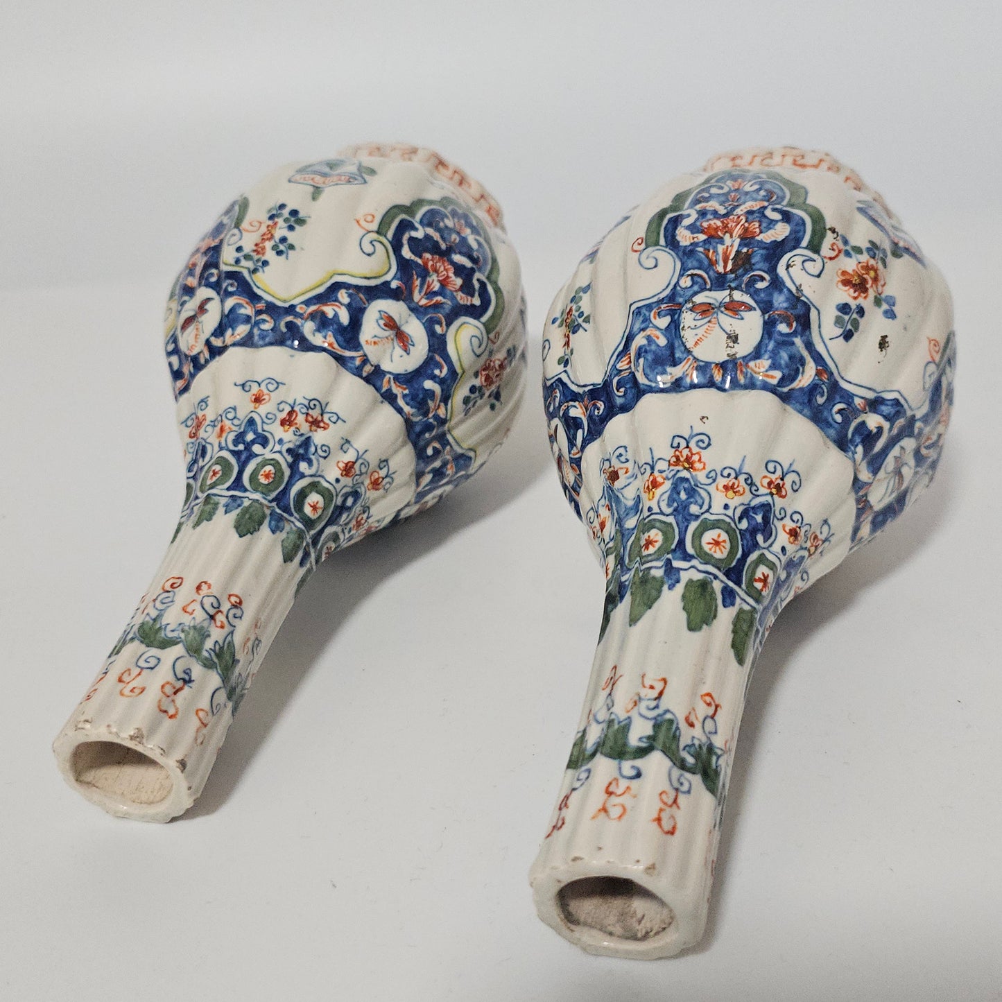 A Matched Pair of Dutch Delft Ribbed Bottle Vases c 1700/1720