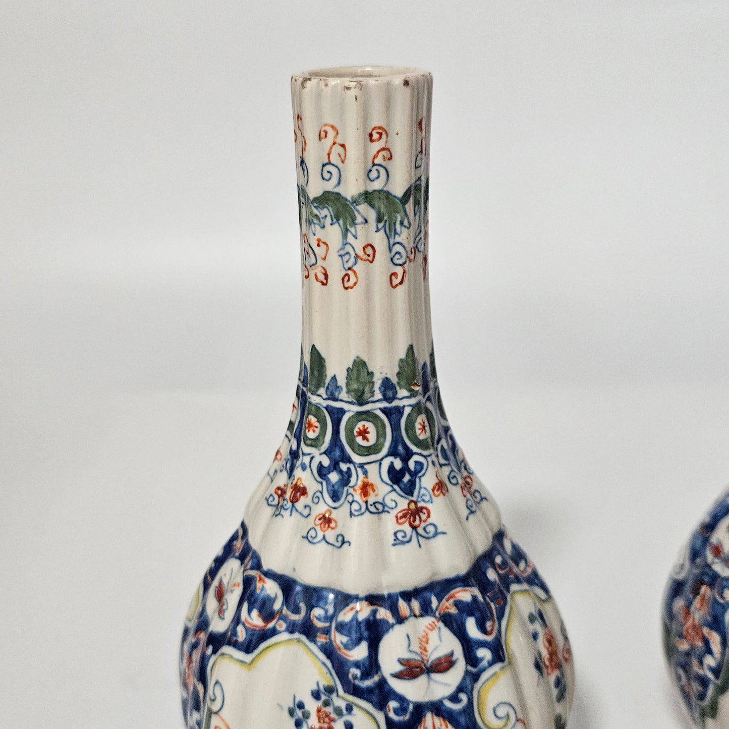 A Matched Pair of Dutch Delft Ribbed Bottle Vases c 1700/1720