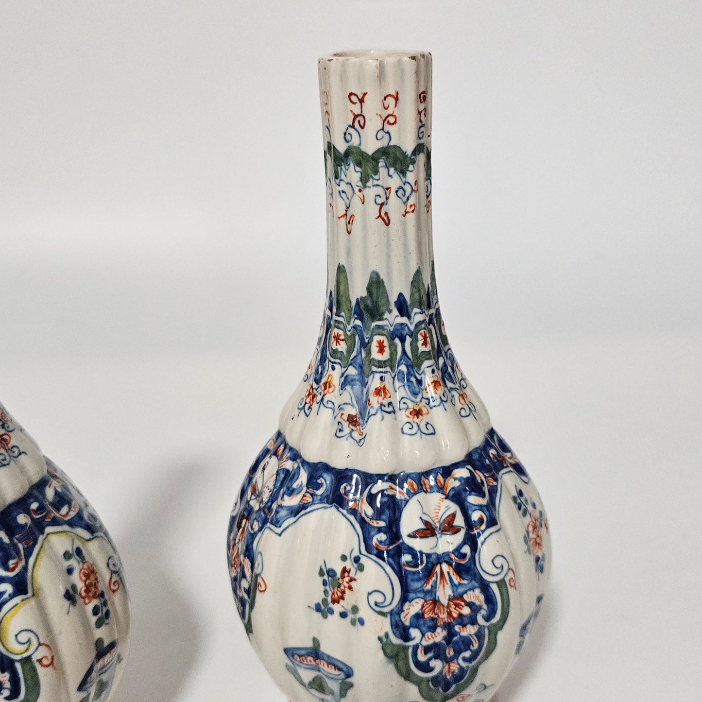 A Matched Pair of Dutch Delft Ribbed Bottle Vases c 1700/1720