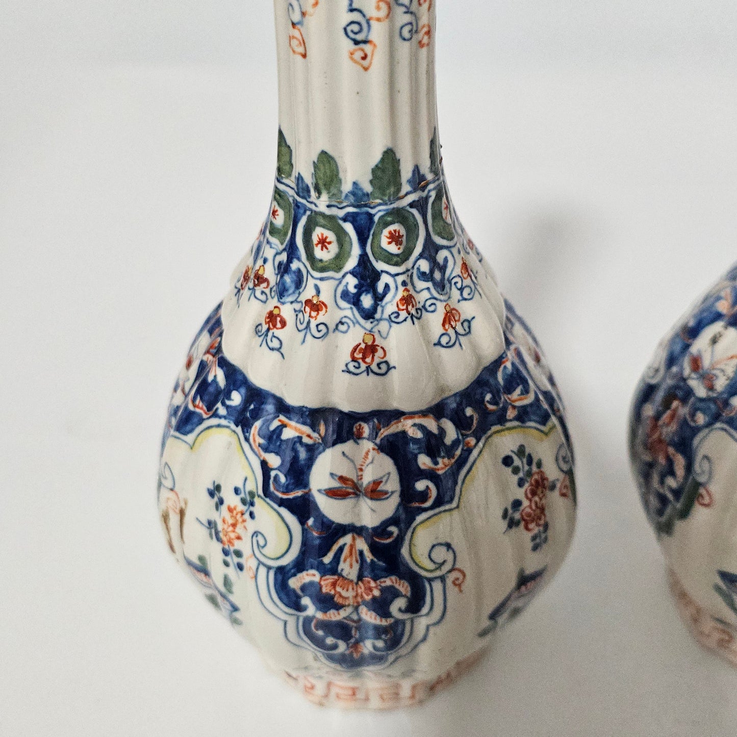 A Matched Pair of Dutch Delft Ribbed Bottle Vases c 1700/1720