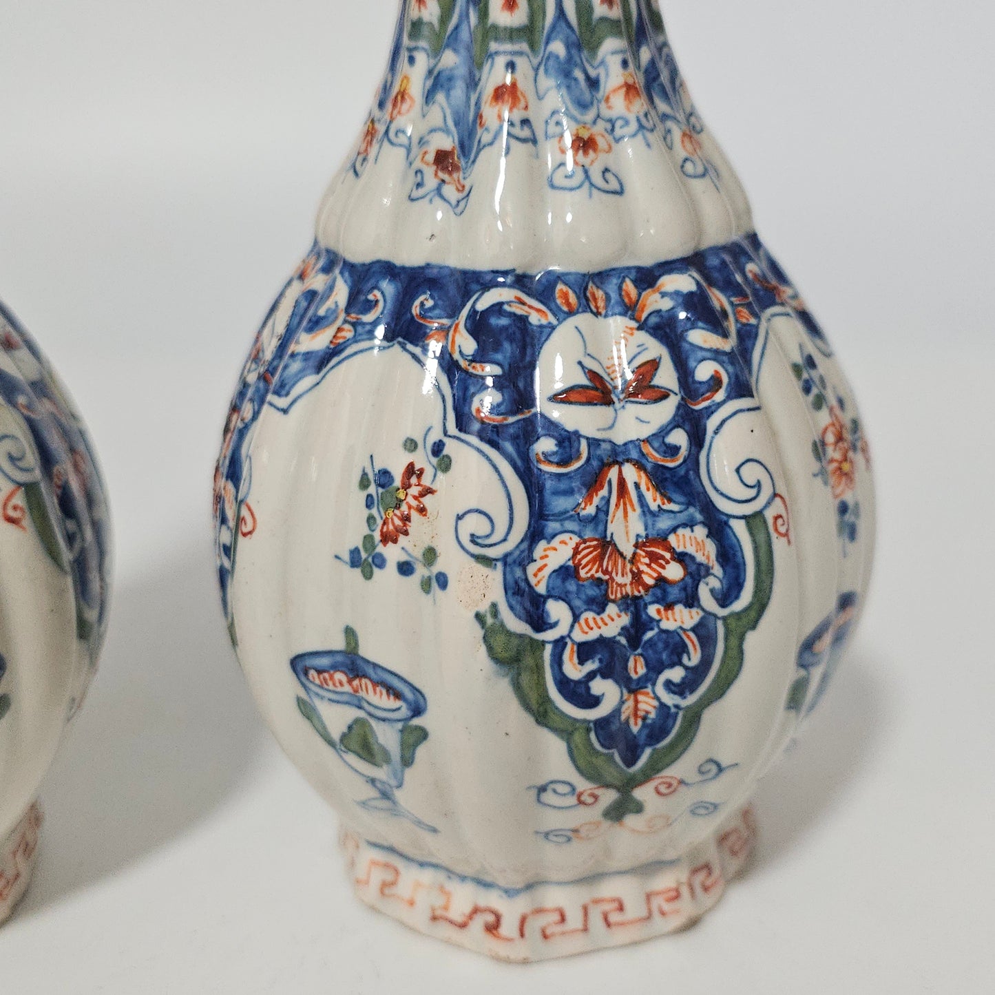 A Matched Pair of Dutch Delft Ribbed Bottle Vases c 1700/1720