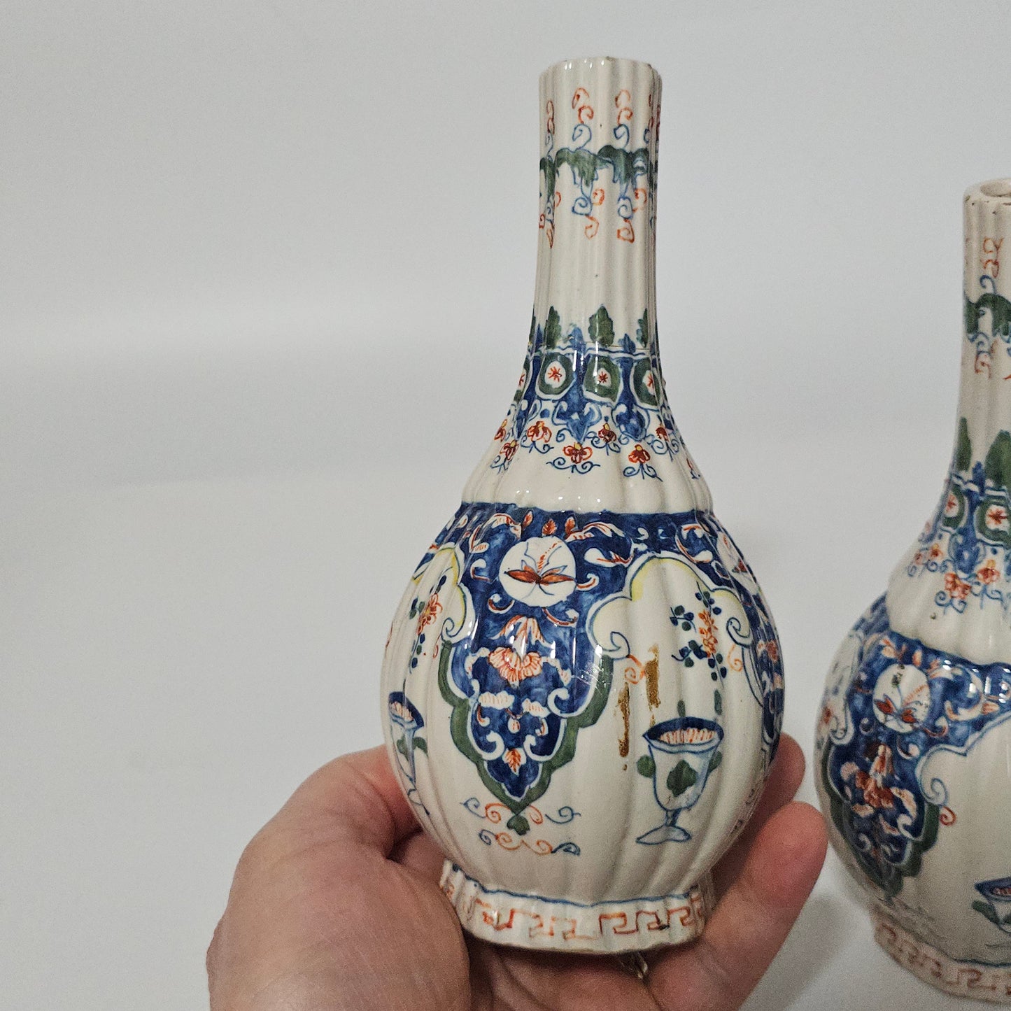 A Matched Pair of Dutch Delft Ribbed Bottle Vases c 1700/1720
