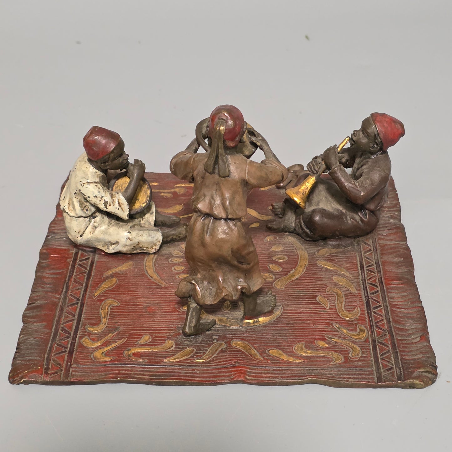 Franz Bergman (Austrian, 1861-1936) An Orientalist cold painted bronze group depicting three musicians on a rug Stamped 'Namgreb and B' and numbered '7813'