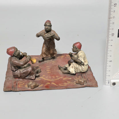 Franz Bergman (Austrian, 1861-1936) An Orientalist cold painted bronze group depicting three musicians on a rug Stamped 'Namgreb and B' and numbered '7813'