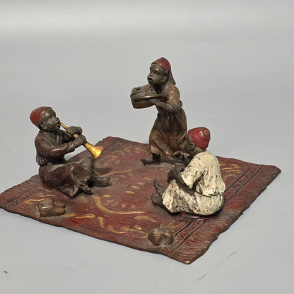 Franz Bergman (Austrian, 1861-1936) An Orientalist cold painted bronze group depicting three musicians on a rug Stamped 'Namgreb and B' and numbered '7813'