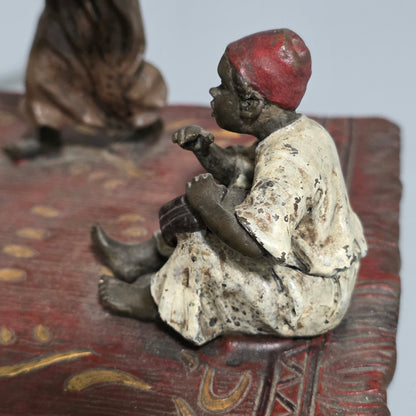 Franz Bergman (Austrian, 1861-1936) An Orientalist cold painted bronze group depicting three musicians on a rug Stamped 'Namgreb and B' and numbered '7813'