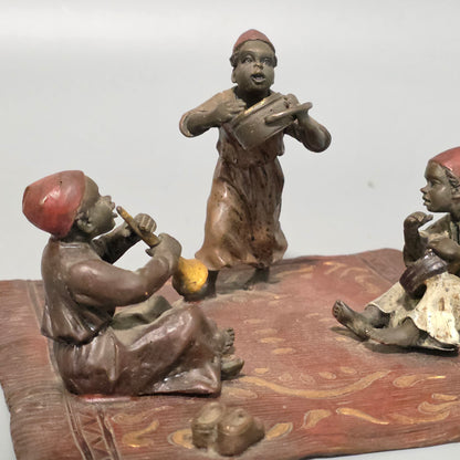 Franz Bergman (Austrian, 1861-1936) An Orientalist cold painted bronze group depicting three musicians on a rug Stamped 'Namgreb and B' and numbered '7813'
