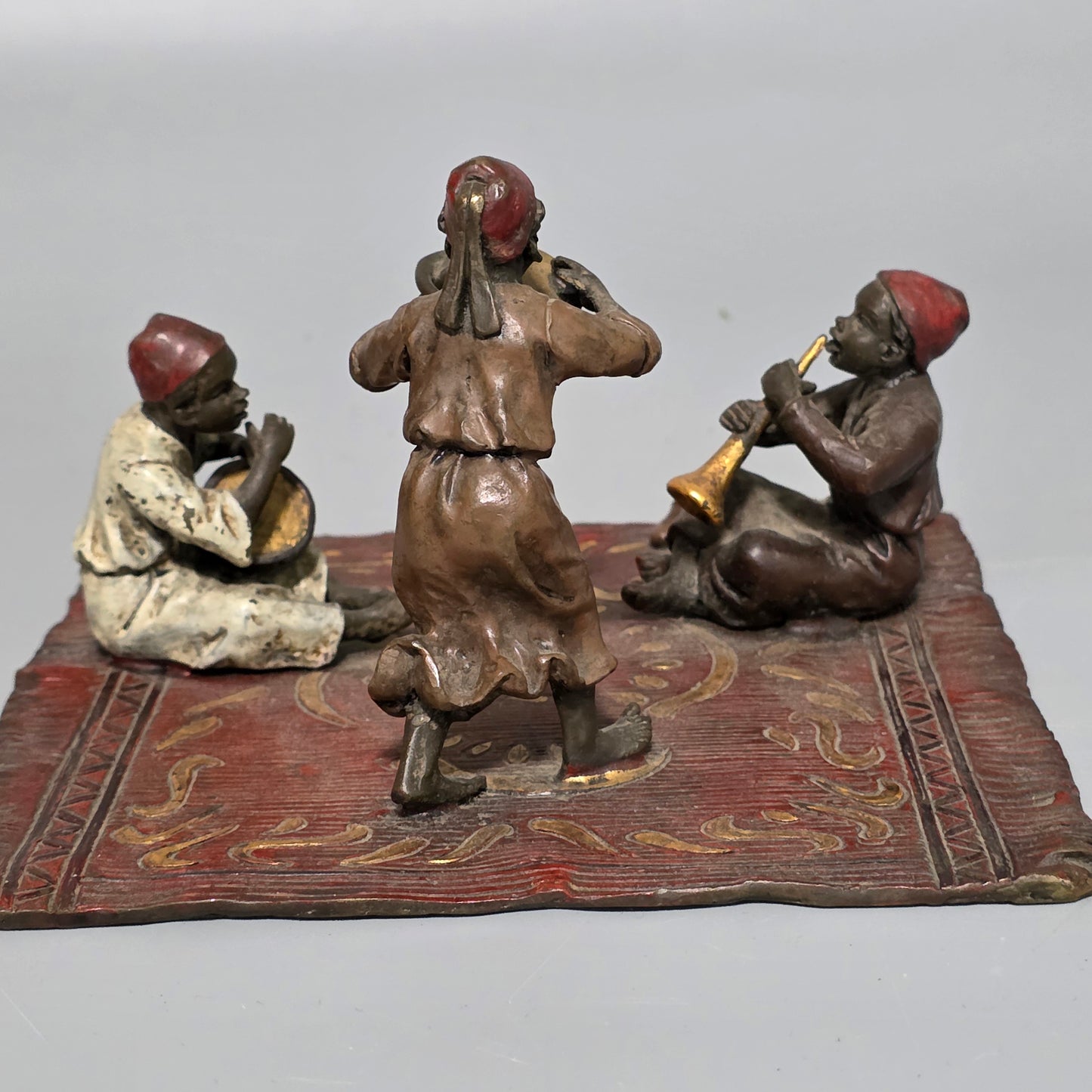 Franz Bergman (Austrian, 1861-1936) An Orientalist cold painted bronze group depicting three musicians on a rug Stamped 'Namgreb and B' and numbered '7813'