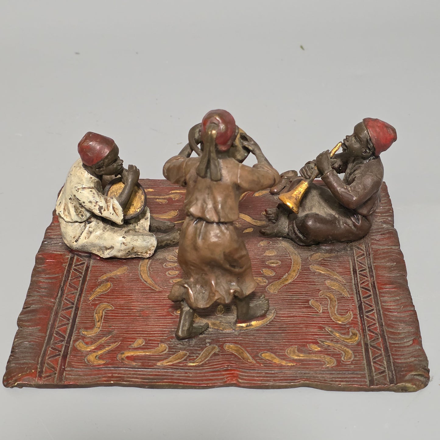 Franz Bergman (Austrian, 1861-1936) An Orientalist cold painted bronze group depicting three musicians on a rug Stamped 'Namgreb and B' and numbered '7813'