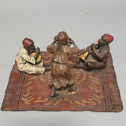 Franz Bergman (Austrian, 1861-1936) An Orientalist cold painted bronze group depicting three musicians on a rug Stamped 'Namgreb and B' and numbered '7813'