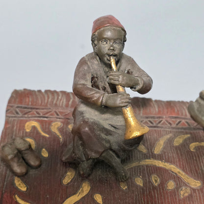 Franz Bergman (Austrian, 1861-1936) An Orientalist cold painted bronze group depicting three musicians on a rug Stamped 'Namgreb and B' and numbered '7813'